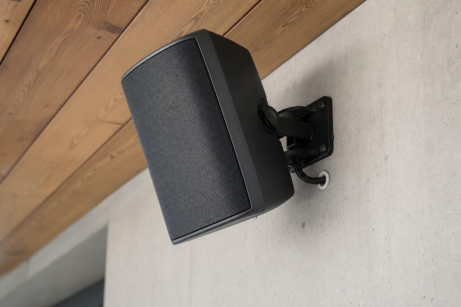 Wall-mounted installation speaker with an adjustable bracket
